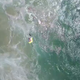 A flotation device is dropped from a drone to the struggling swimmers.